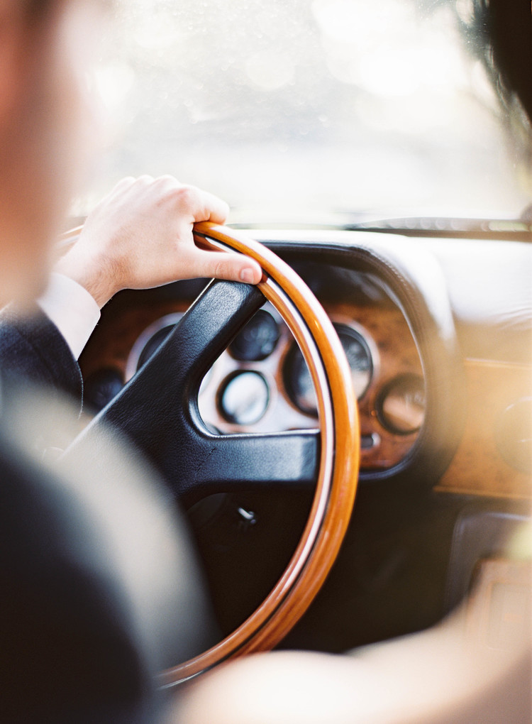 Detailed shot of the black and wood steering wheel in the getaway car