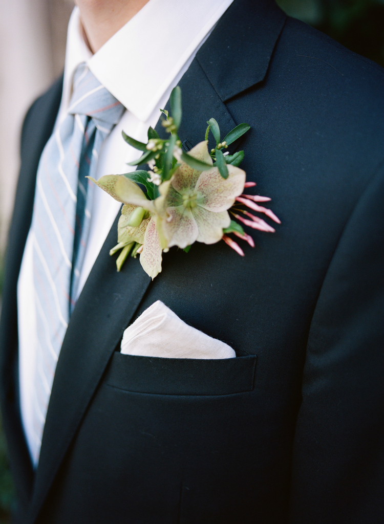 grooms orchid boutonniere with pink accents, blue striped tie and a white pocket square